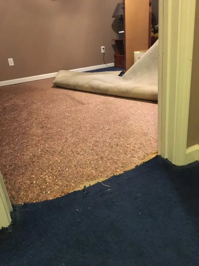 Carpet pad removal revealing water damage during Drying & Dehumidification in Burkburnett